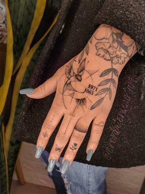 A Woman With Tattoos On Her Hand And Wrist