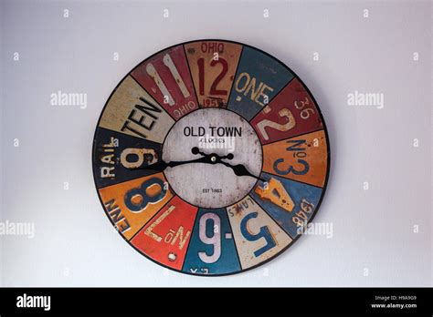 Colorful vintage clock on white wall Stock Photo - Alamy