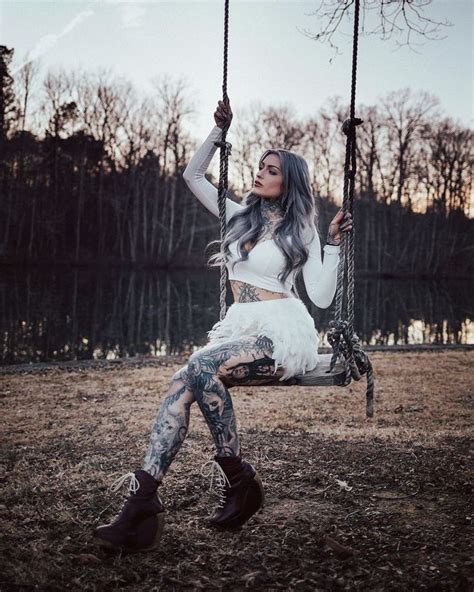 A Woman With Grey Hair Sitting On A Swing