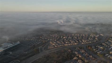 Flying Over A Neighborhood Of Central Valley In California Fog Rises