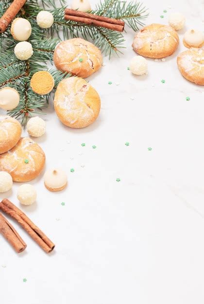 Caramelos y galletas con ramas de árboles de navidad sobre fondo de