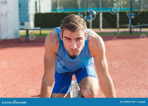 Male Athlete Ready For A Race In A Sprint Starting Position Stock