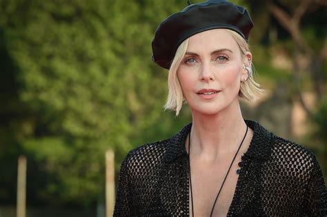 Charlize Theron Pairs Black Swimsuit With Mesh Dress In New Photos Parade