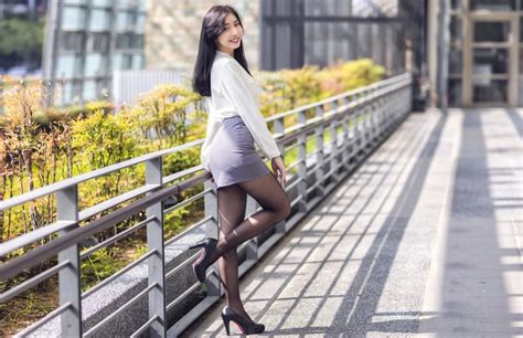 4k Asian Fence Brunette Girl Smile Pose Skirt Legs Stilettos