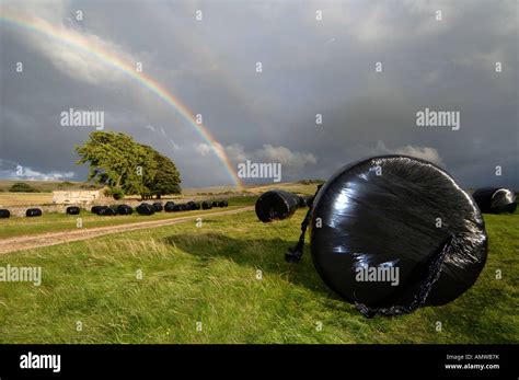 Big Bales Of Silage Under A Rainbow Cumbria Stock Photo Alamy