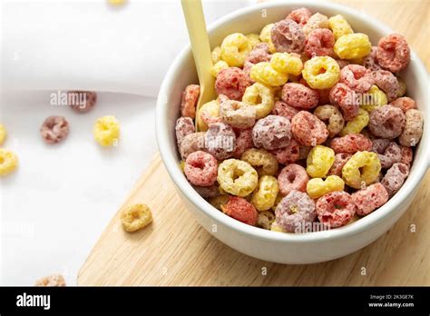 Healthy Food Concept Colorful Ring Cereals In Bowl On Saucer Wooden And Falling On White Cloth