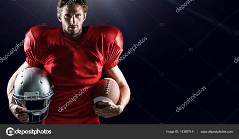 American Football Player Holding Helmet And Ball Stock Photo By