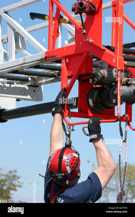 An aerial rescue using a ladder truck with the firefighter hooking up ...