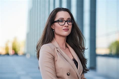 Free Photo Portrait Of Smart Brunette In Glasses On The Street With Interesting Architecture