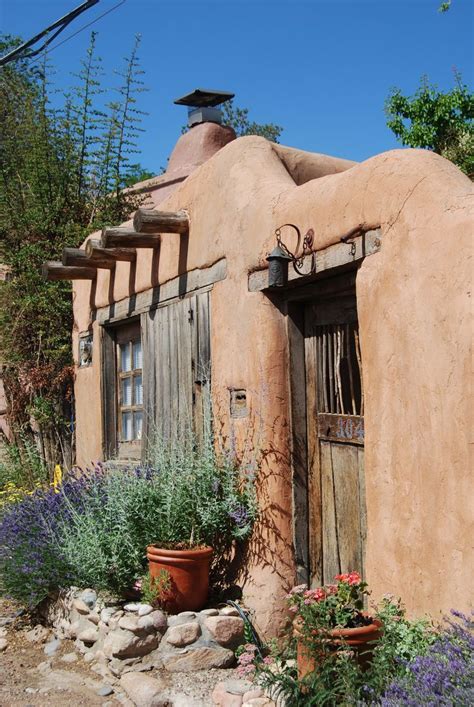 Flowers Adobe Wall And Weathered Door Santa Fe New Mexico Usa