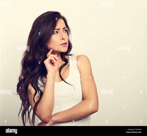 Confusion Grimacing Brunette Woman Thinking And Looking Up In White T