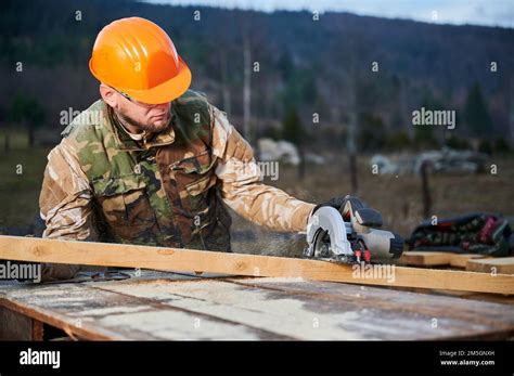 Carpenter Using Circular Saw For Cutting Wooden Joist Man Worker