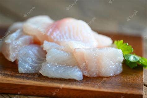 Premium Photo | Fish fillet on wooden board with ingredients celery for ...