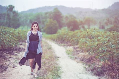 Carefree Happy Woman Enjoying Nature On The Street With Grass Meadow