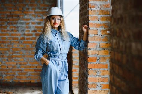 Construction Concept. Pretty Female Builder in Overalls and Helmet ...