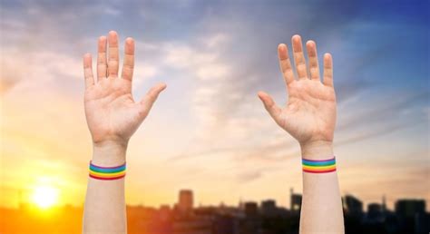 Premium Photo Hands With Gay Pride Rainbow Wristbands