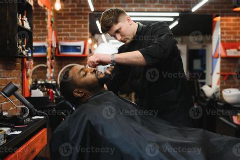 Side view of serious man with stylish modern haircut looking forward in ...