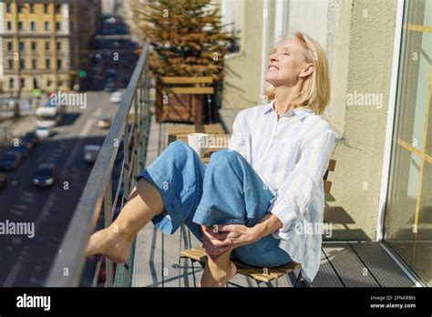 Mature Woman Relaxing On Terrace High Resolution Stock Photography And