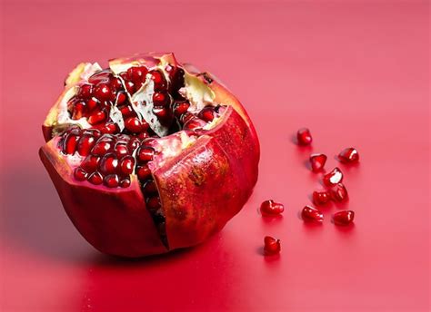 Premium Photo Pomegranate On A Red Background Broken Ripe Pomegranate