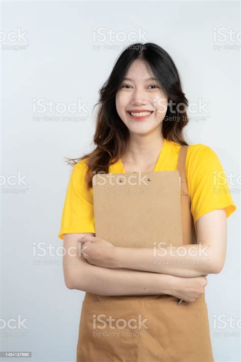 Portrait Of A Beautiful Asian Woman Standing Over White Background With