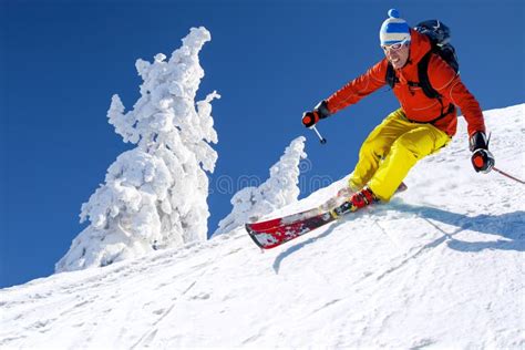 Skier Skiing Downhill In High Mountains Against Cable Lift Stock Image