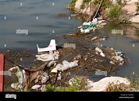 River Pollution Caused By Human Waste And Discarded Rubbish In A