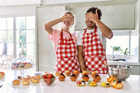 Couple Of Wife And Husband Cooking Pastries At The Kitchen Smiling And Laughing With Hand On