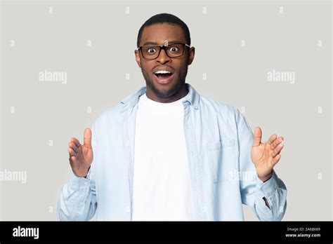 Head Shot Excited African American Man Showing Big Size Gesture Stock