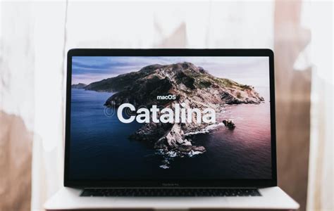 MacBook With Mac OS Catalina Background Logo On The Screen. Editorial ...