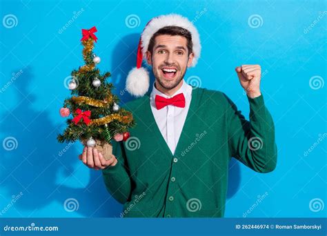 Photo Of Positive Lucky Man Wear X Mas Green Cardigan Rising Fist Holding Pine Isolated Blue