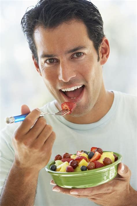 Mid Adult Man Eating Fresh Fruit Salad Stock Photo Image Of Indoors