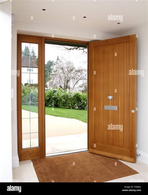 Lomax+Wood quality front door with glass side panels Stock Photo - Alamy