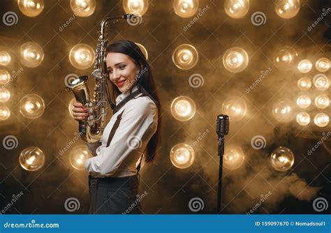 Female Saxophonist Poses With Saxophone On Stage Editorial Image