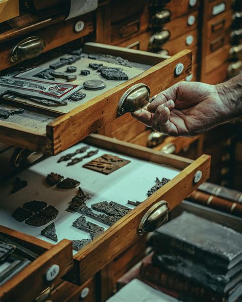 Old Artisan Showing Vintage and Antique Artifacts in Wooden Drawers · Free Stock Photo