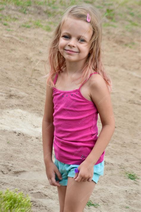 Premium Photo Portrait Of Smiling Girl Standing Outdoors