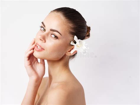 Attractive Woman With Flower Make Up In Hair Nude Shoulders Stock Photo