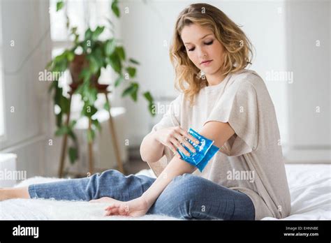 Woman Using A Hot Cold Gel Pack Treatment To Releive Pain Stock Photo Alamy