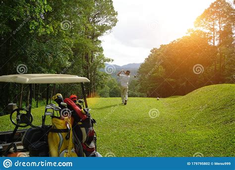 Blurred Golfer Playing Golf Beside The Golfcar In Beautiful Golf Course