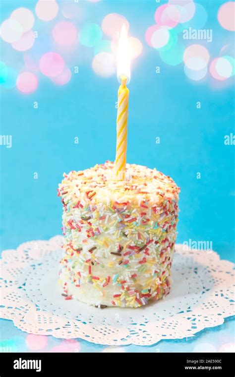 Birthday Cake With A Burning Candle Stock Photo Alamy