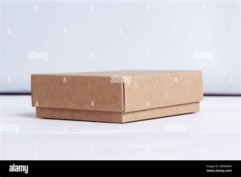 Cardboard Box Package Isolated On White Wood Background Craft Paper