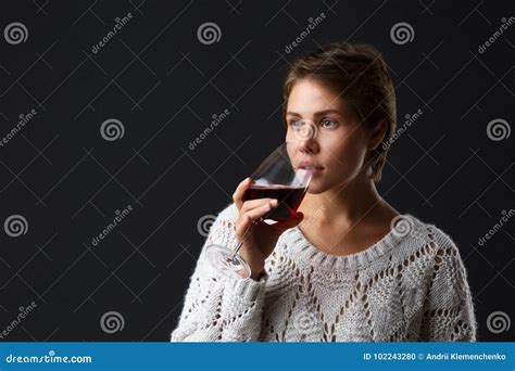 Beautiful Girl With A Glass Of Red Wine On A Black Background Stock