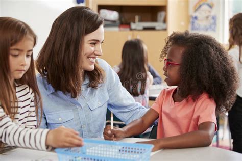 Female Primary School Teacher And Girls In Class Close Up Stock Image Image Of Holding