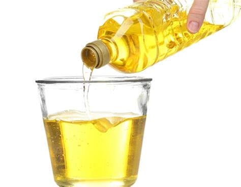 Premium Photo Pouring Cooking Oil Into Glass On White Background