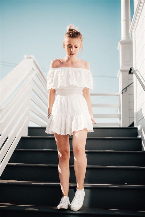 Woman Walking Down Stair Under Clear Blue Sky During Daytime HD Phone