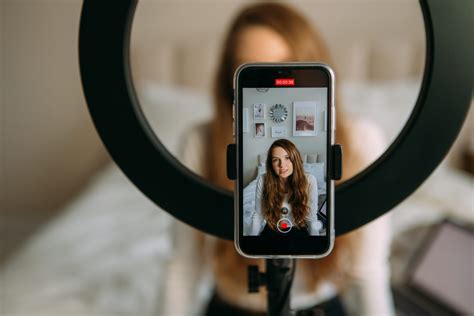 500px Photo ID: 1037762092 - young woman records video on phone, phone ...