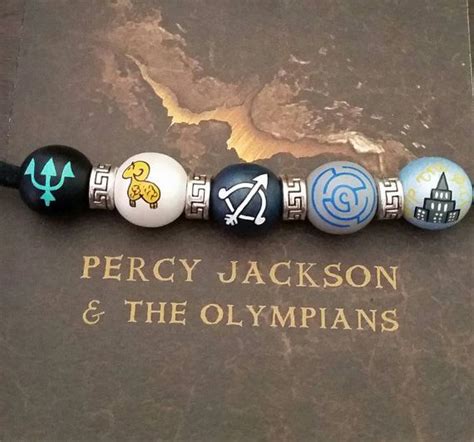 A Book That Has Some Kind Of Keychain On It With The Words Percy