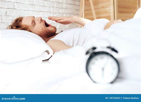 Young Red Haired Guy Wakes Up Yawning In Bed Stock Image Image Of