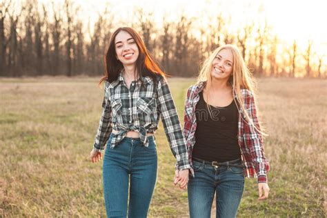 Two Young Women Having Fun On The Field Stock Image Image Of Sitting