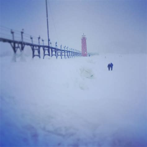 Lighthouse On Lake Michigan Frozen Over In Grand Haven Michigan