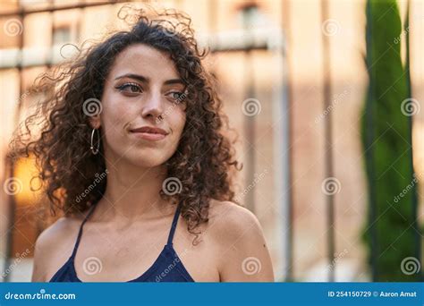 Young Beautiful Hispanic Woman Standing With Serious Expression At